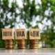 Wooden blocks with text IRA ROTH 401K. Business and finance concept.