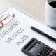 retirement plan on desk with some coffee and a calculator