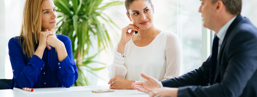 Businesspeople collaborating and talking through new ideas in office